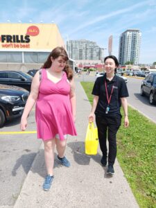 Client and care provider run errands together in the city