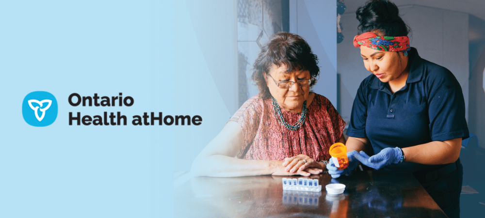 Worker helps patient with medication management, Ontario Health atHome logo to the left